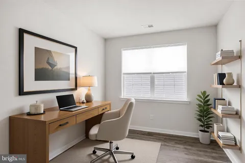 an empty room with wooden floor and a window