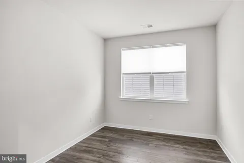a kitchen with stainless steel appliances kitchen island granite countertop a refrigerator and a stove top oven