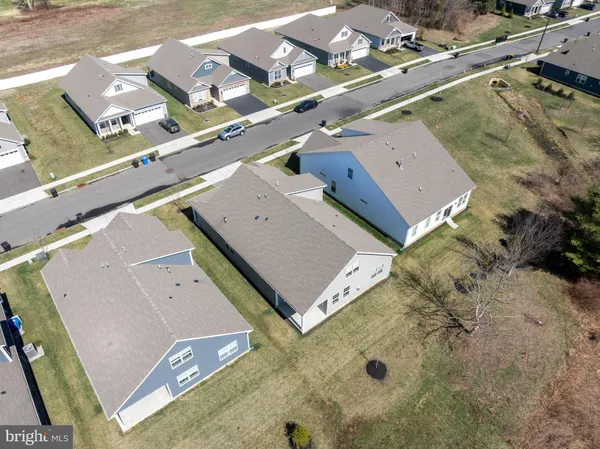 an aerial view of residential house with parking