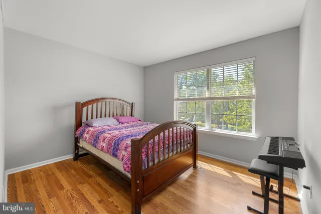 a bed sitting in a bedroom next to a window