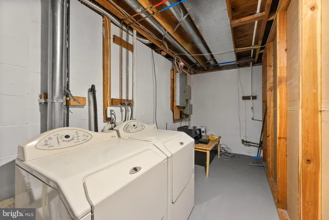 a view of a patio with a table and chairs under an umbrella