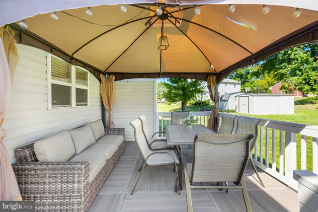 a view of outdoor dining space with a patio and wooden floor