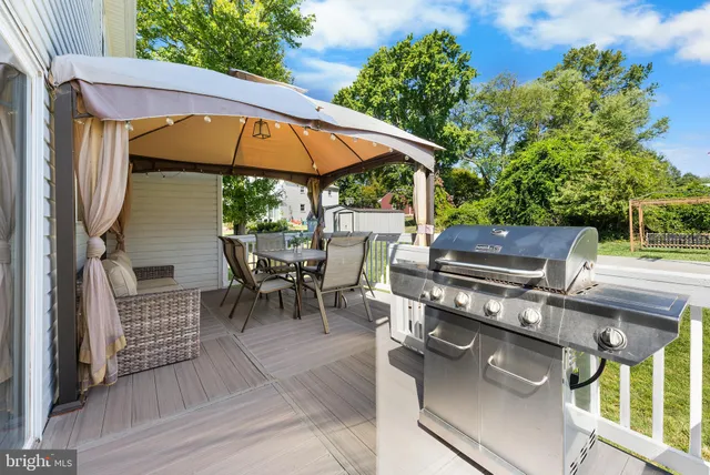 a view of a house with a yard and sitting area