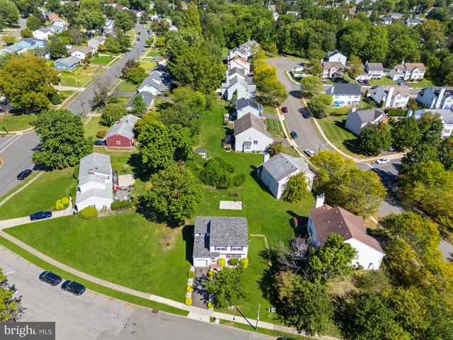 an aerial view of residential houses with outdoor space and street view