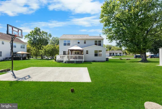 a view of house with a backyard