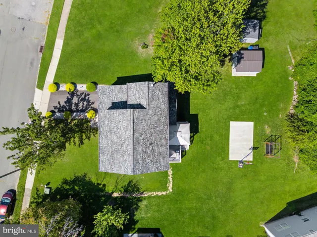 an aerial view of a house with backyard