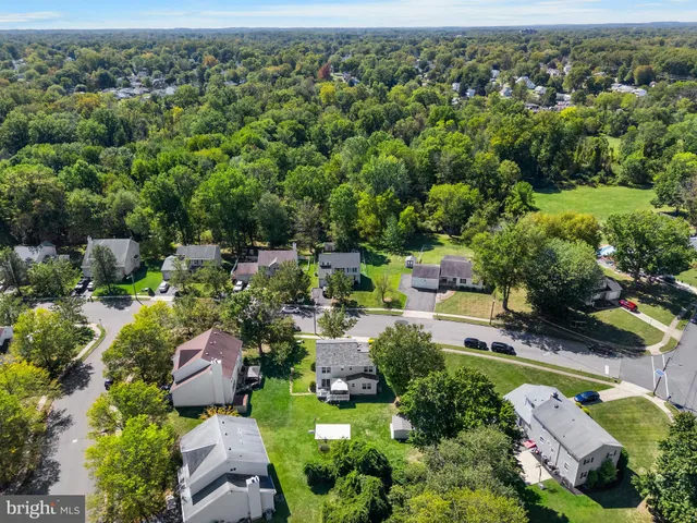 an aerial view of a city with lots of residential buildings and mountain view in back