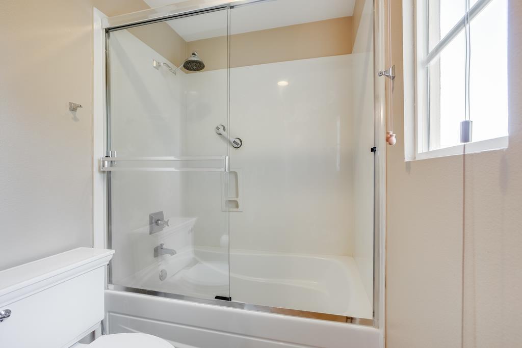 1420 Dahlia Loop San Jose, CA 95126 - Photo 17 of 36 a bathroom with a glass shower door and a window