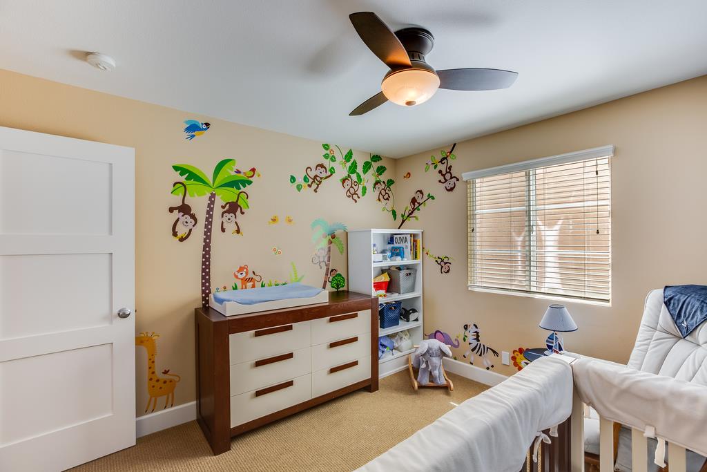 1420 Dahlia Loop San Jose, CA 95126 - Photo 24 of 36 a bedroom with a bed and a chandelier