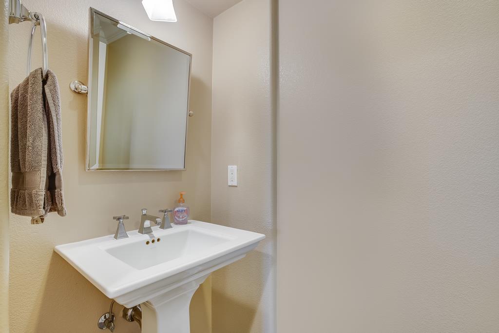 1420 Dahlia Loop San Jose, CA 95126 - Photo 27 of 36 a bathroom with a sink and a mirror