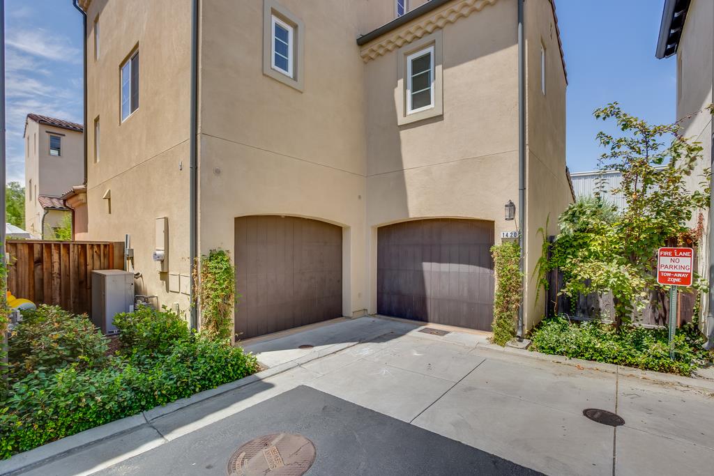1420 Dahlia Loop San Jose, CA 95126 - Photo 31 of 36 a front view of a house with a yard and garage