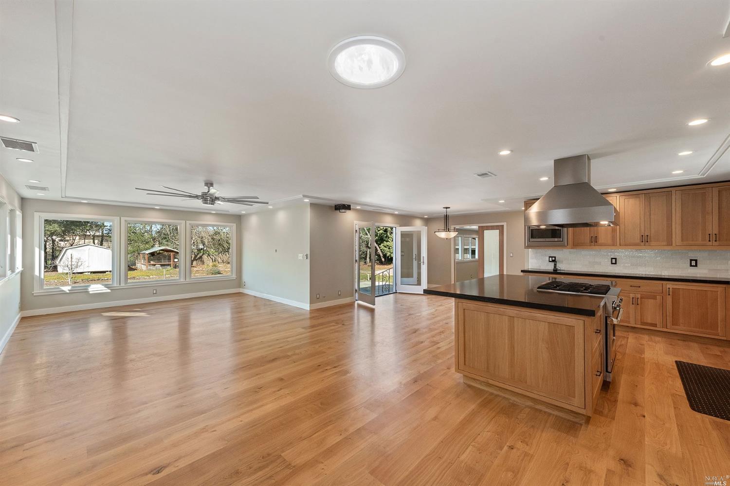 a large kitchen with a lot of counter space and a wooden floor