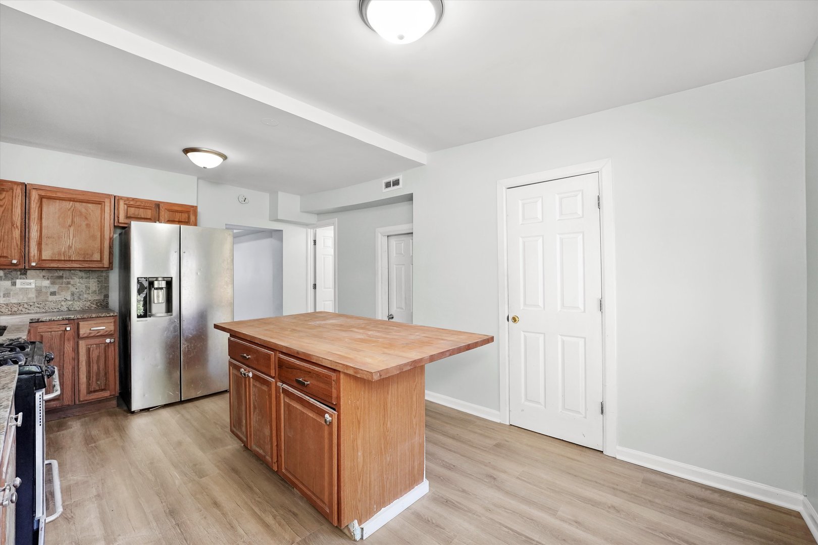 2230 West 24th Street, Unit 1 Chicago, IL 60608 - Photo 8 of 13 a kitchen with stainless steel appliances granite countertop a sink stove and refrigerator