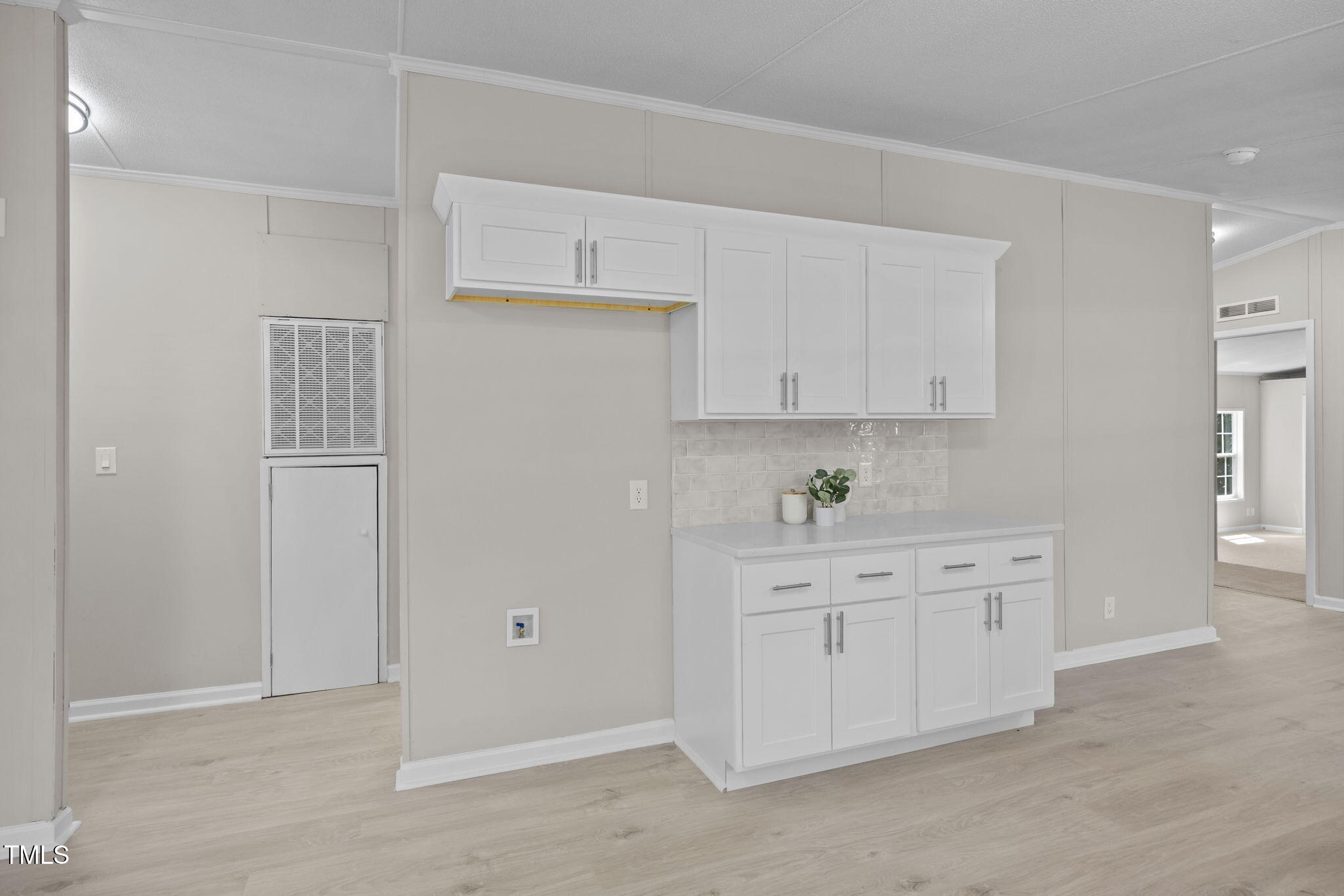 261 Ragland Lane Henderson, NC 27537 - Photo 11 of 58 a kitchen with white cabinets and white appliances