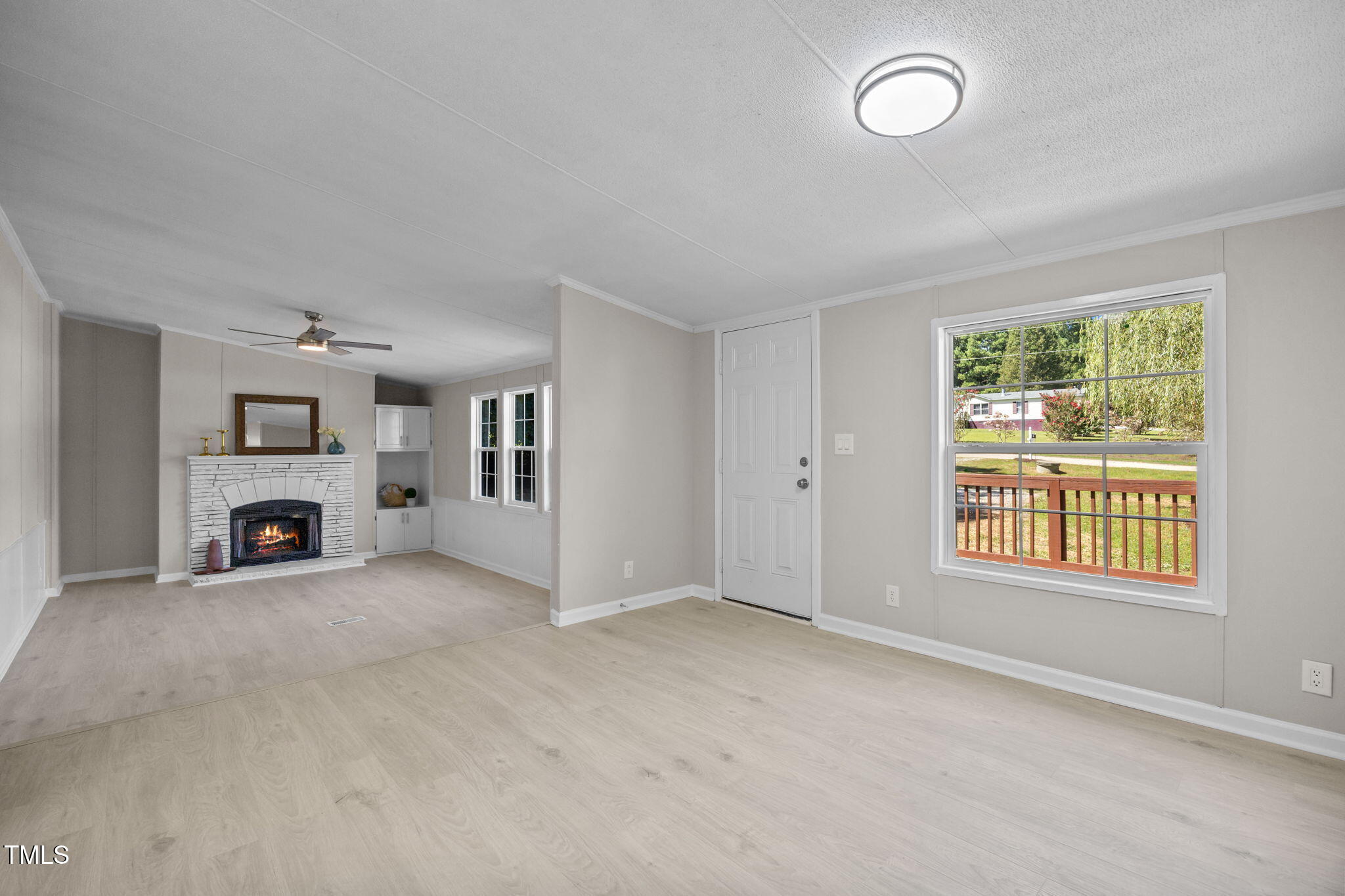 261 Ragland Lane Henderson, NC 27537 - Photo 13 of 58 an empty room with furniture and a fireplace