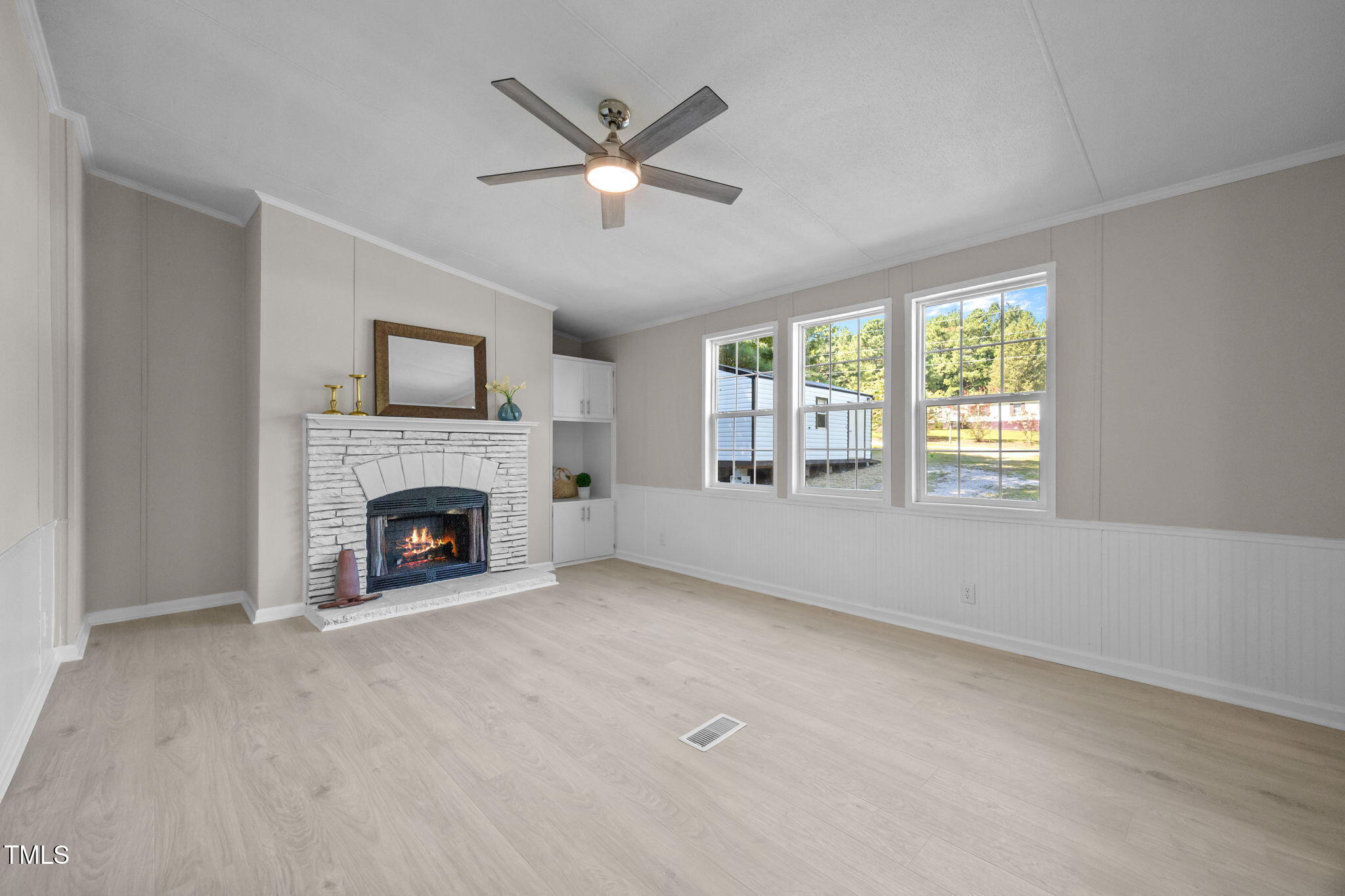 261 Ragland Lane Henderson, NC 27537 - Photo 14 of 58 a view of a livingroom with a fireplace a ceiling fan and windows