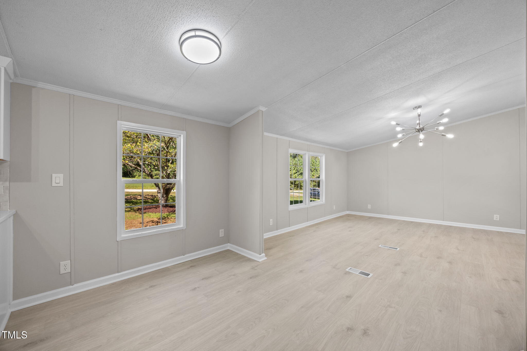 261 Ragland Lane Henderson, NC 27537 - Photo 18 of 58 an empty room with windows and mirror