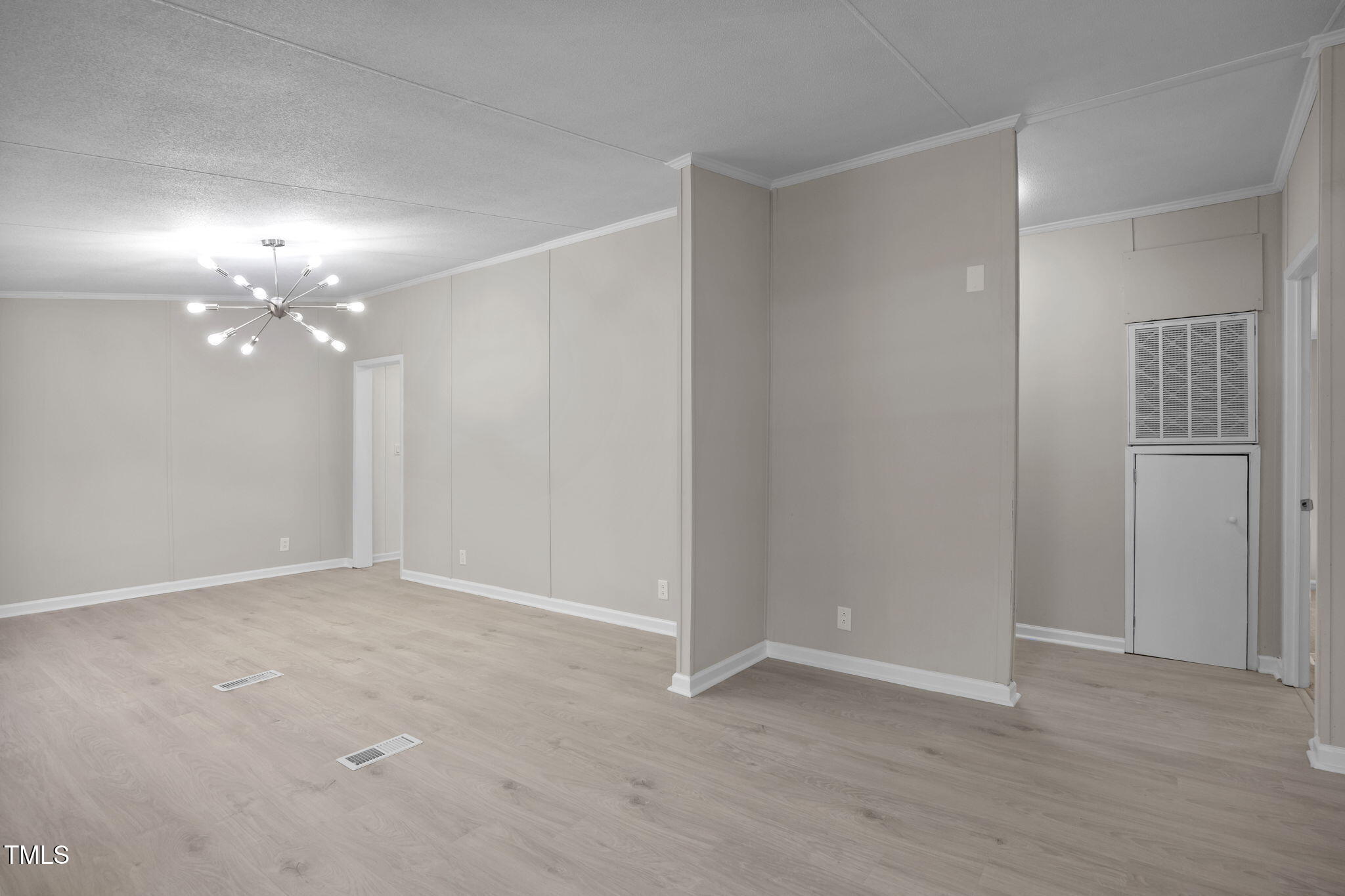 261 Ragland Lane Henderson, NC 27537 - Photo 19 of 58 a view of an empty room with a chandelier fan