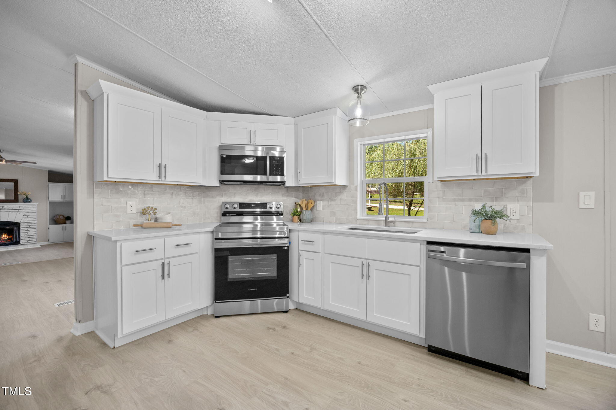 261 Ragland Lane Henderson, NC 27537 - Photo 2 of 58 a kitchen with granite countertop white cabinets and stainless steel appliances