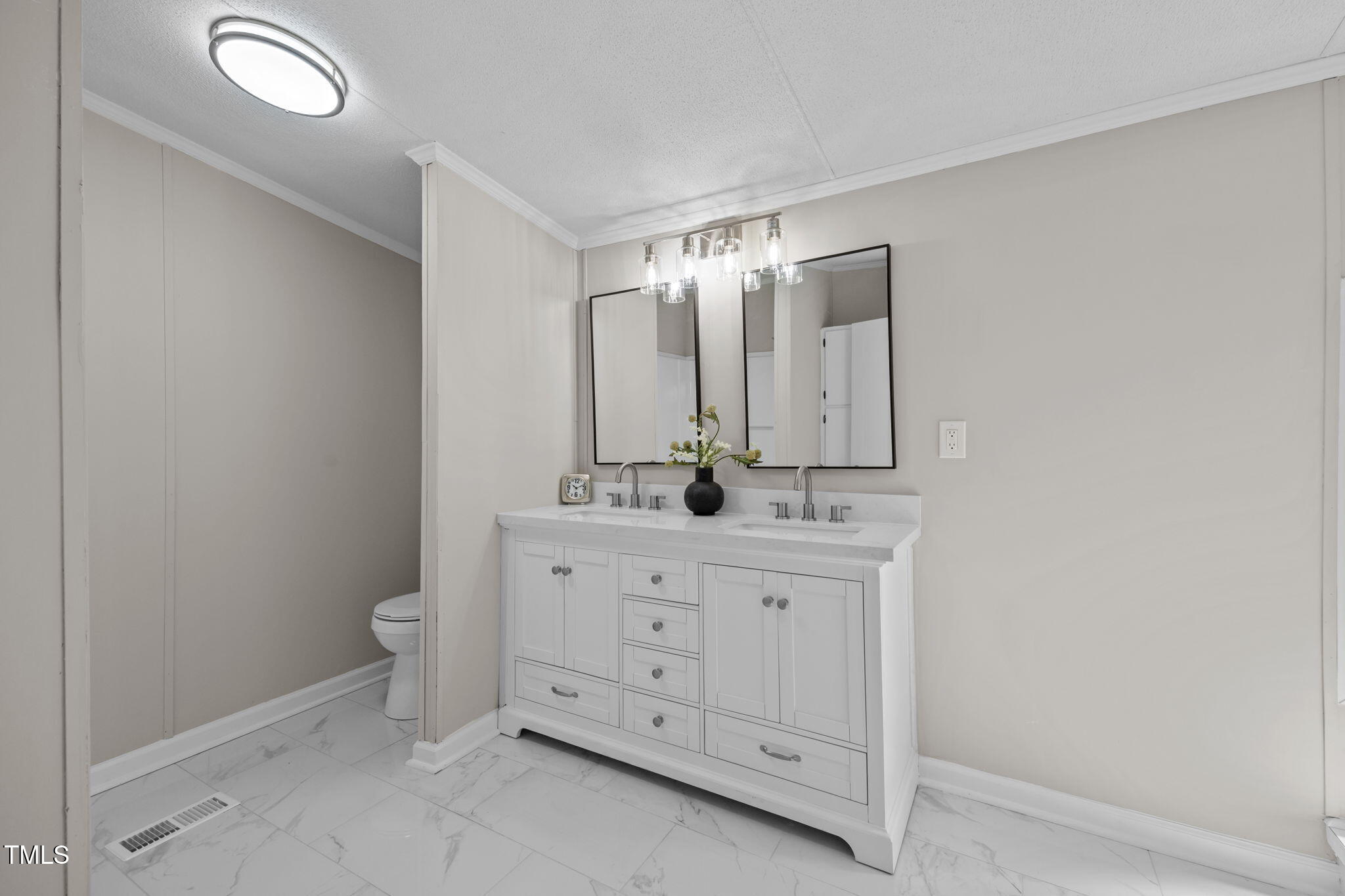 261 Ragland Lane Henderson, NC 27537 - Photo 32 of 58 a bathroom with a double vanity sink and mirror