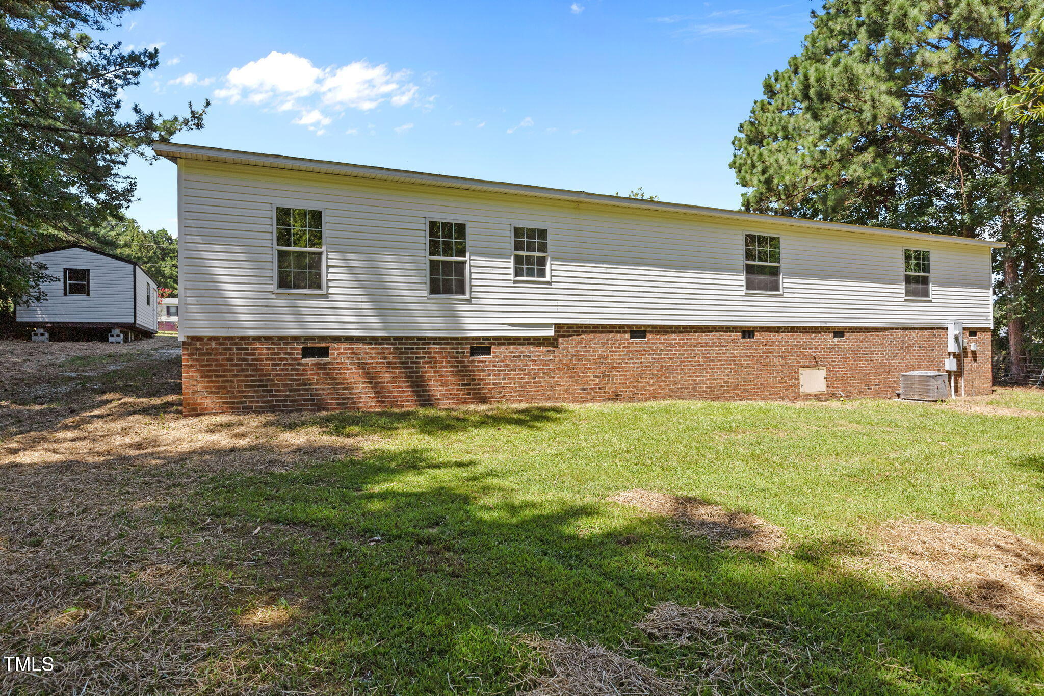 261 Ragland Lane Henderson, NC 27537 - Photo 41 of 58 a backyard of a house with table and chairs