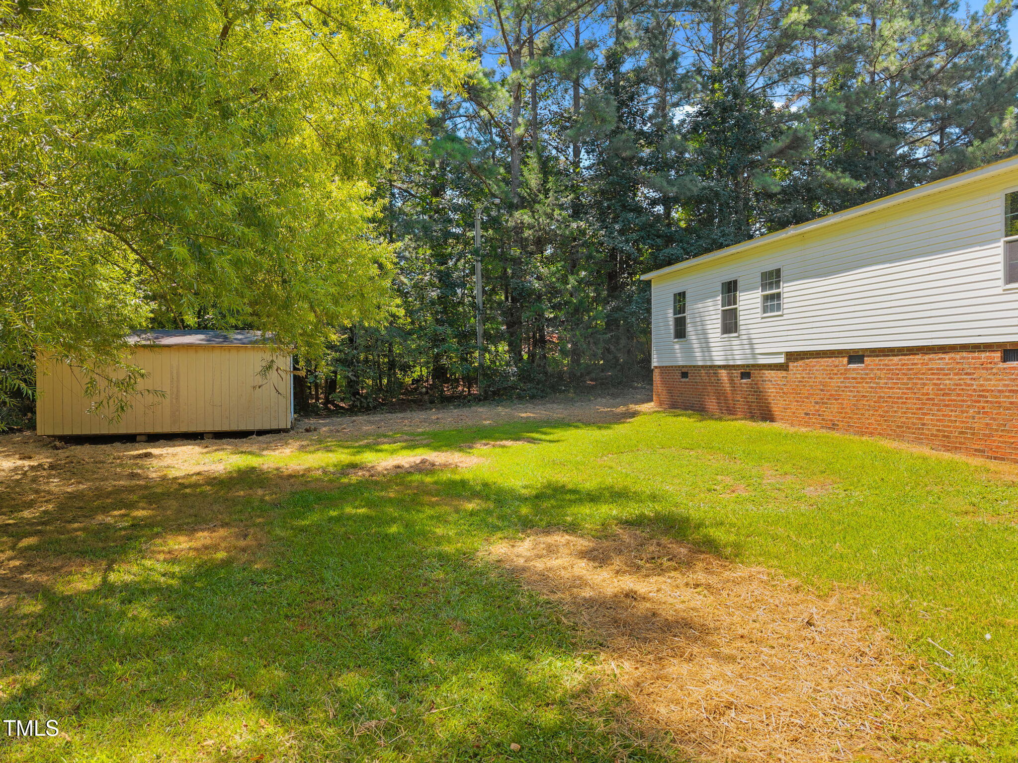 261 Ragland Lane Henderson, NC 27537 - Photo 43 of 58 a view of a house with a yard and a large tree