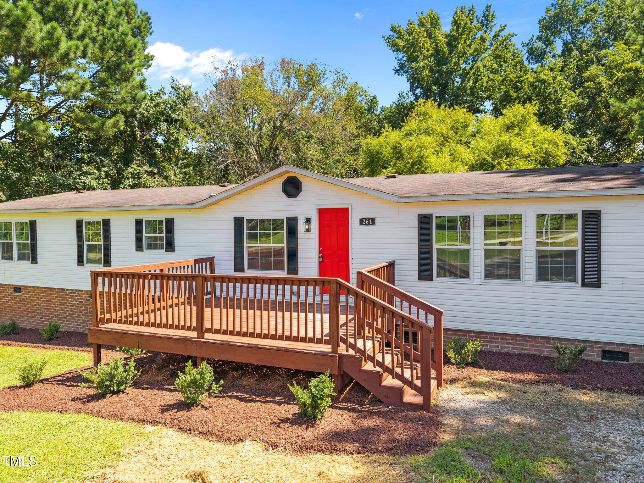 261 Ragland Lane Henderson, NC 27537 - Photo 47 of 58 a view of a house with a small yard and wooden fence