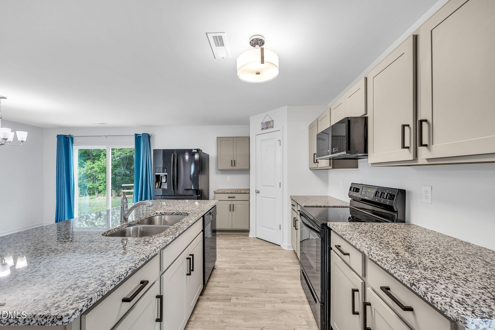 177 Yellowwood Avenue Spring Hope, NC 27882 - Photo 10 of 31 a kitchen with stainless steel appliances granite countertop a sink stove microwave and refrigerator