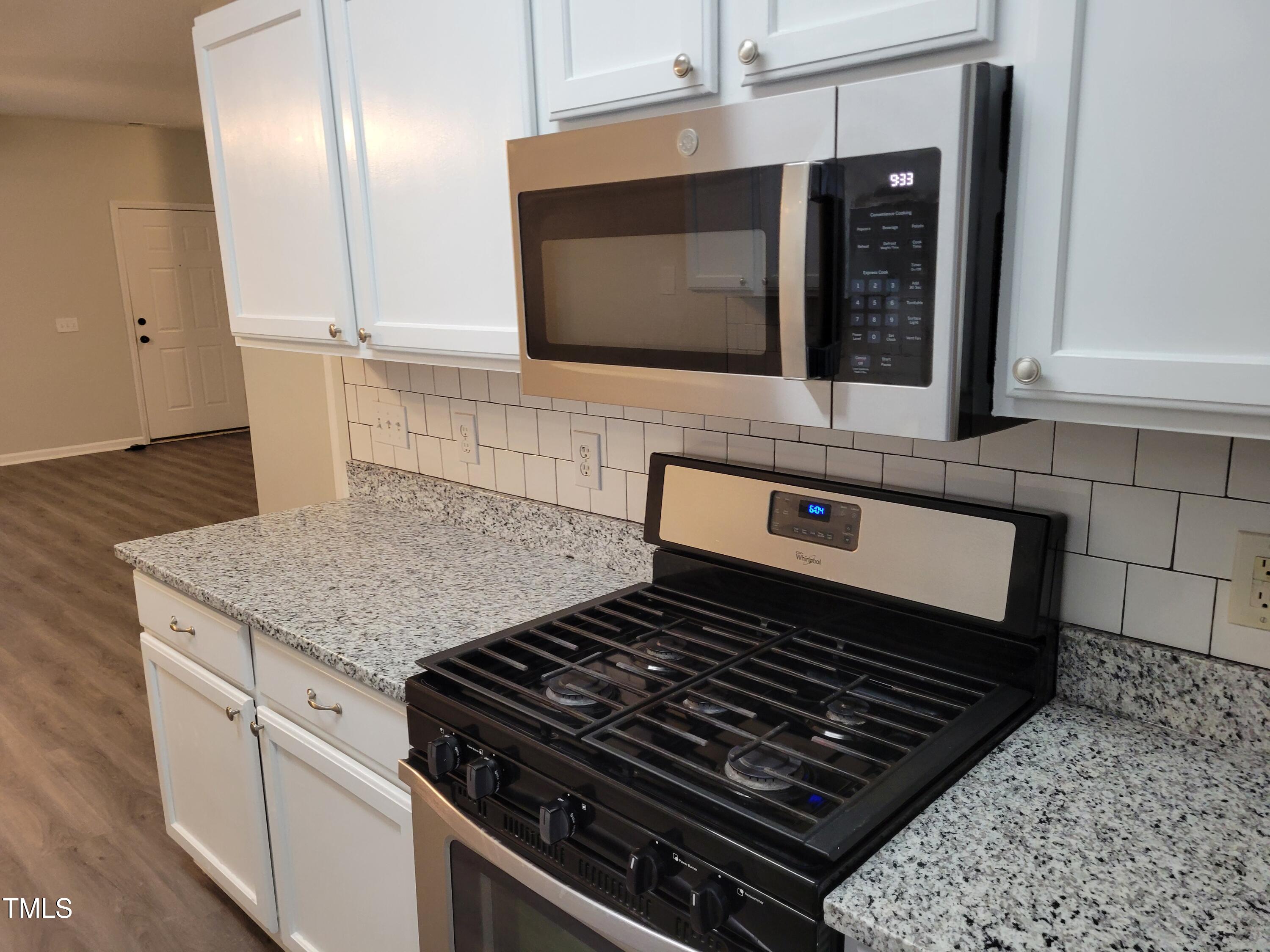 4416 Pottery Lane Raleigh, NC 27616 - Photo 5 of 14 New granite tops and tile backsplash and brand new microwave over 5 burner gas stove & cooktop