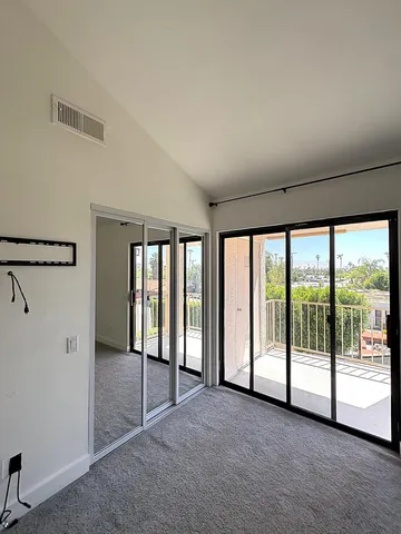 a view of empty room with floor to ceiling window