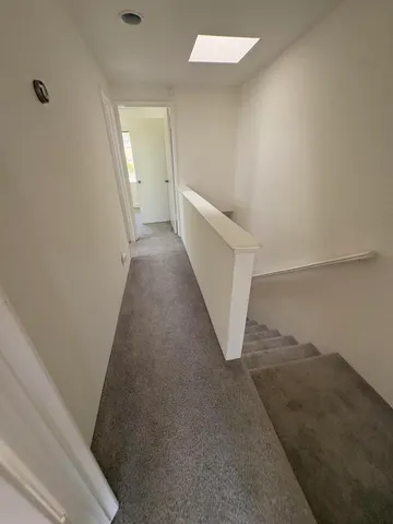 a view of a hallway view with staircase