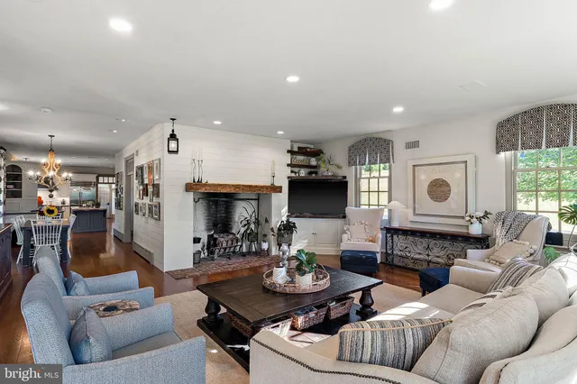 a spacious bedroom with a bed and wooden floor