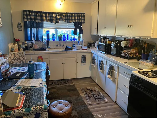 a kitchen with a sink stove and cabinets