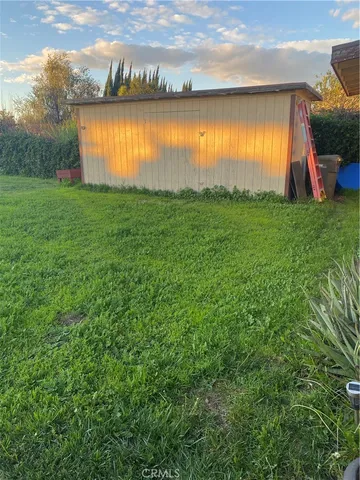 a view of a house with a yard and sitting area