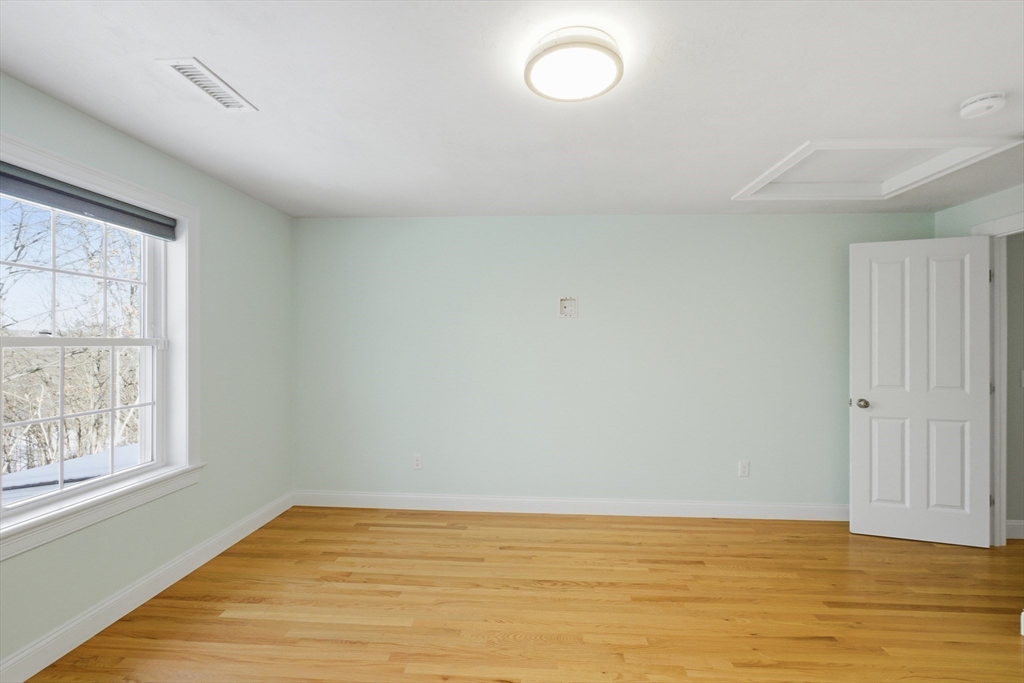 2 Turtle Lane, Unit 2 Sterling, MA 01564 - Photo 31 of 40 a view of an empty room with wooden floor and a window