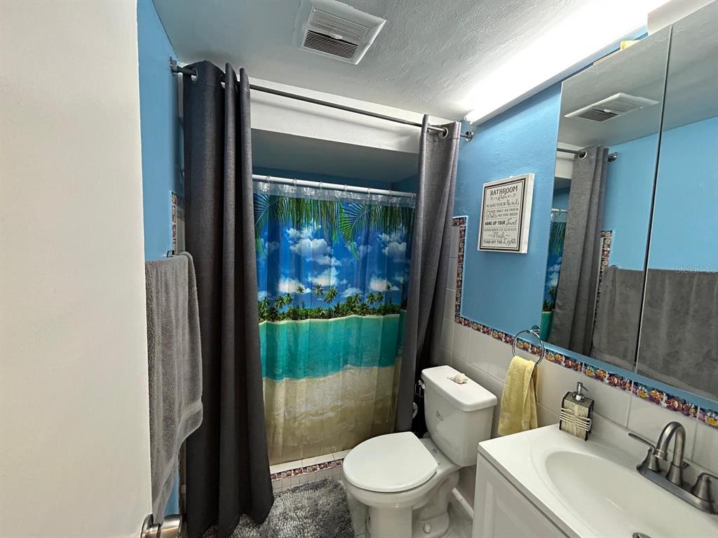 Undisclosed Address New Port Richey, FL 34652 - Photo 18 of 25 a bathroom with a sink toilet and shower