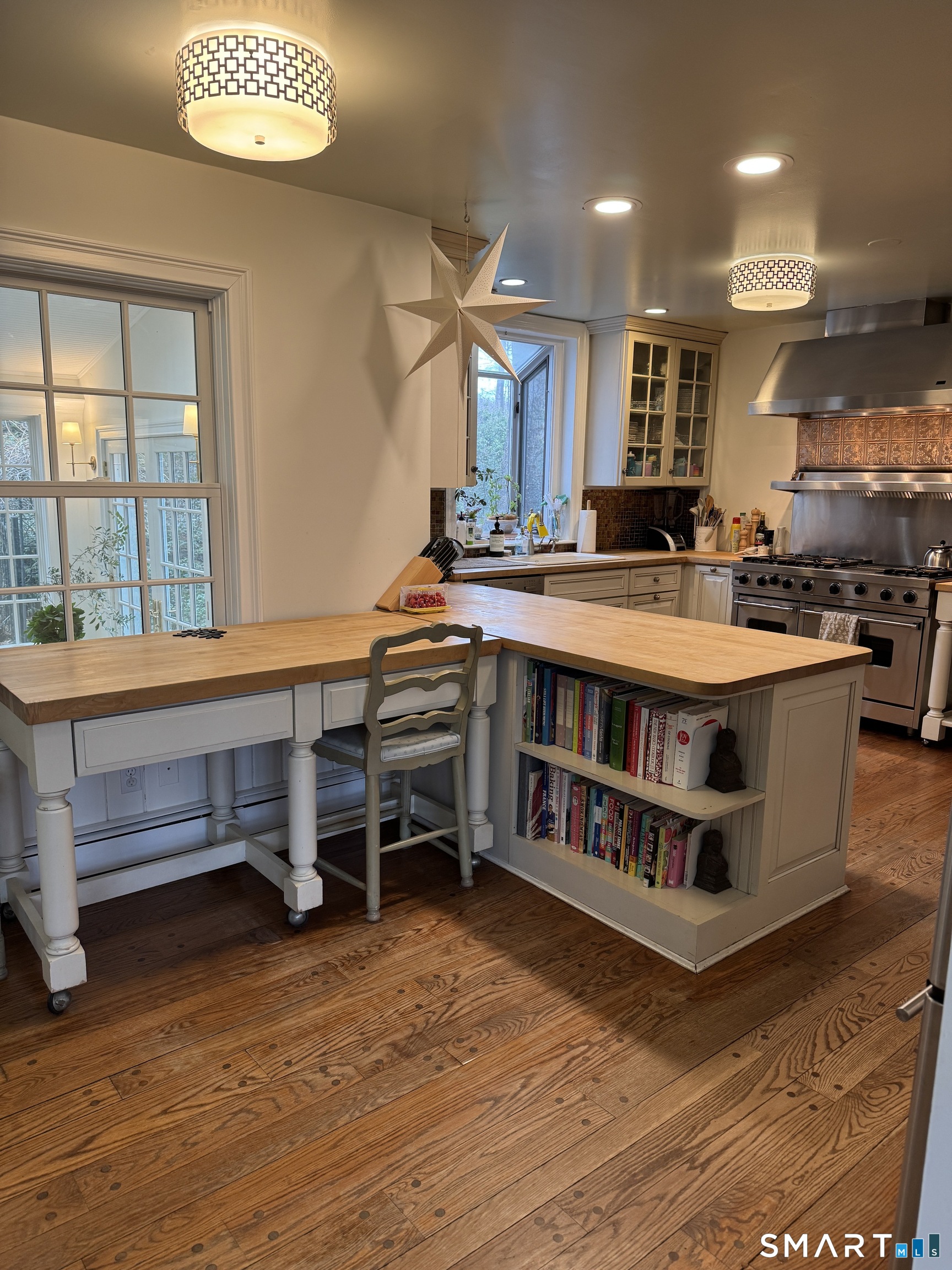 301 Old Norwalk Road New Canaan, CT 06840 - Photo 10 of 27 a large white kitchen with a large counter top and outdoor seating