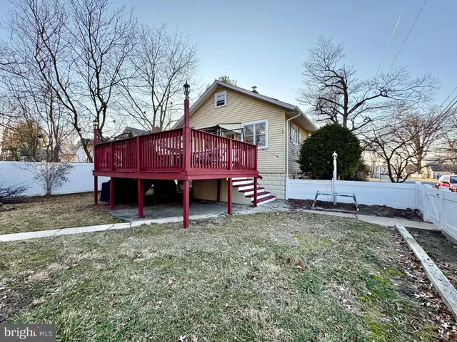 a view of a house with a yard and deck