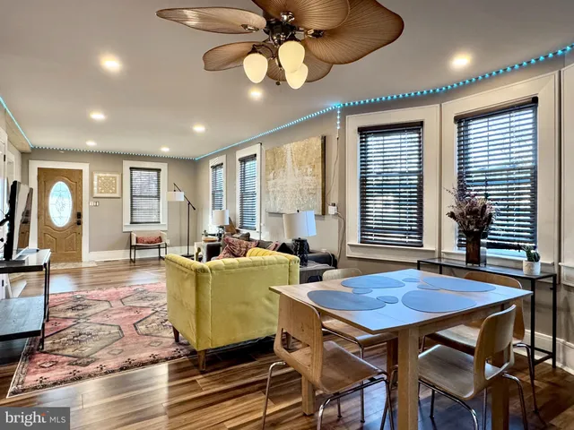 a living room with furniture a window and a chandelier