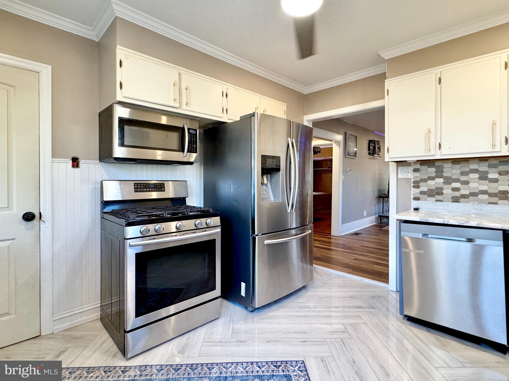 301 Linderman Avenue Cherry Hill, NJ 08002 - Photo 9 of 23 a kitchen with stainless steel appliances granite countertop a stove a refrigerator and a microwave