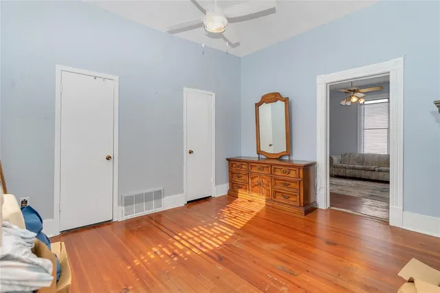 a view of empty room with window and a ceiling fan