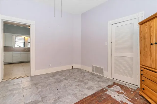 a white toilet sitting next to a bathroom sink and vanity