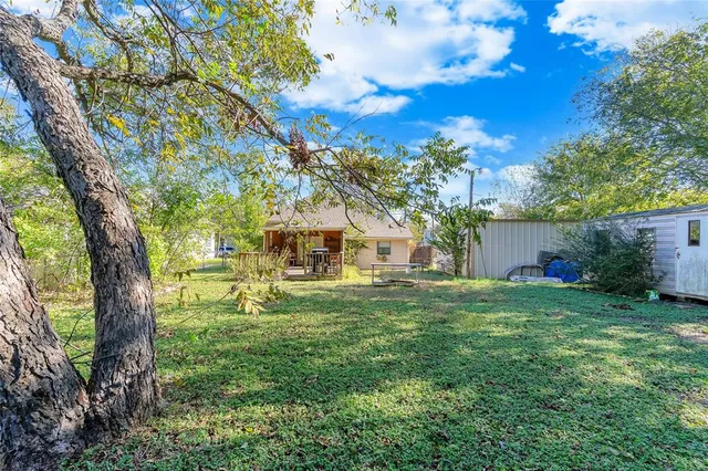 an aerial view of a house with a yard and trees