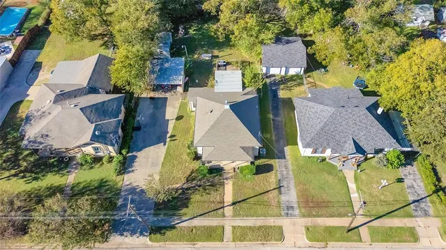 an aerial view of residential houses with outdoor space