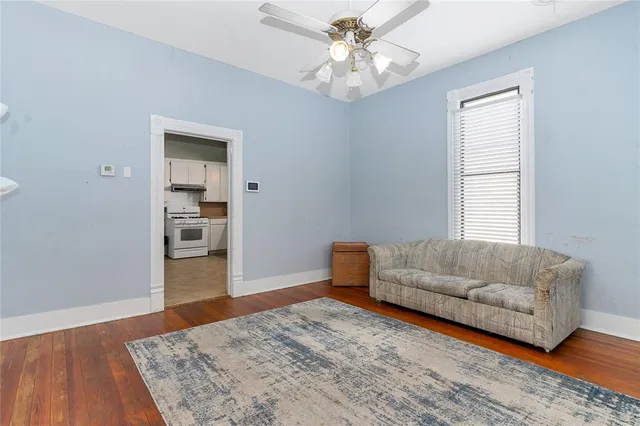 a living room with a bed furniture and a window