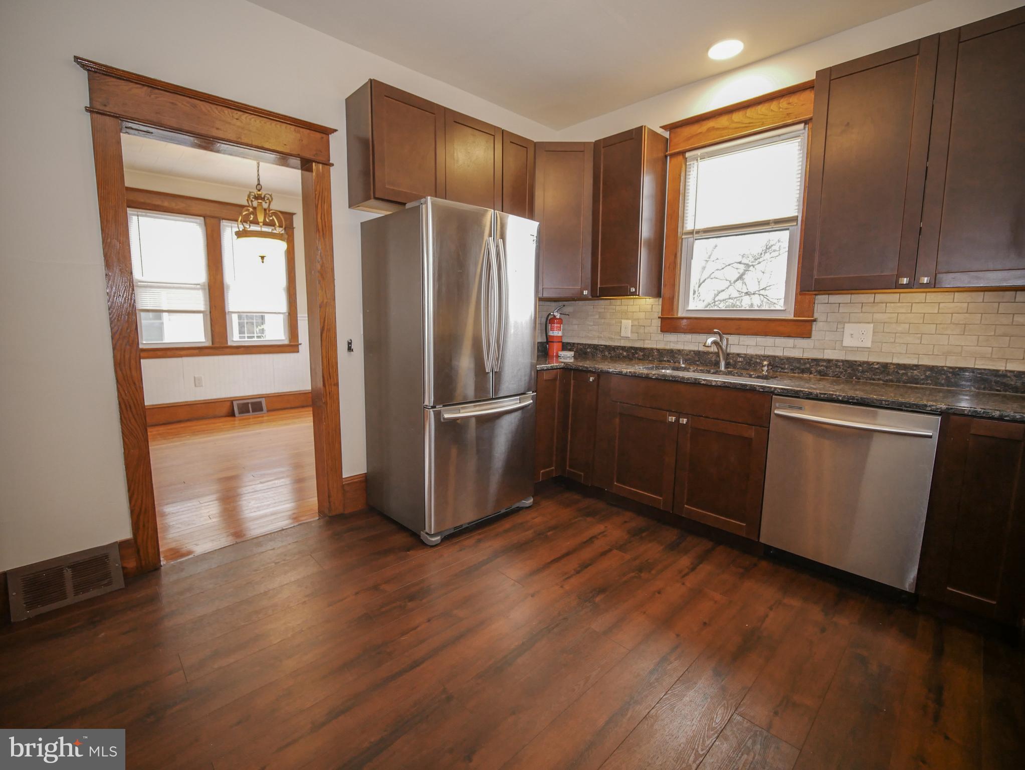 332 Crown Point Road Thorofare, NJ 08086 - Photo 15 of 36 a kitchen with wooden floors and stainless steel appliances