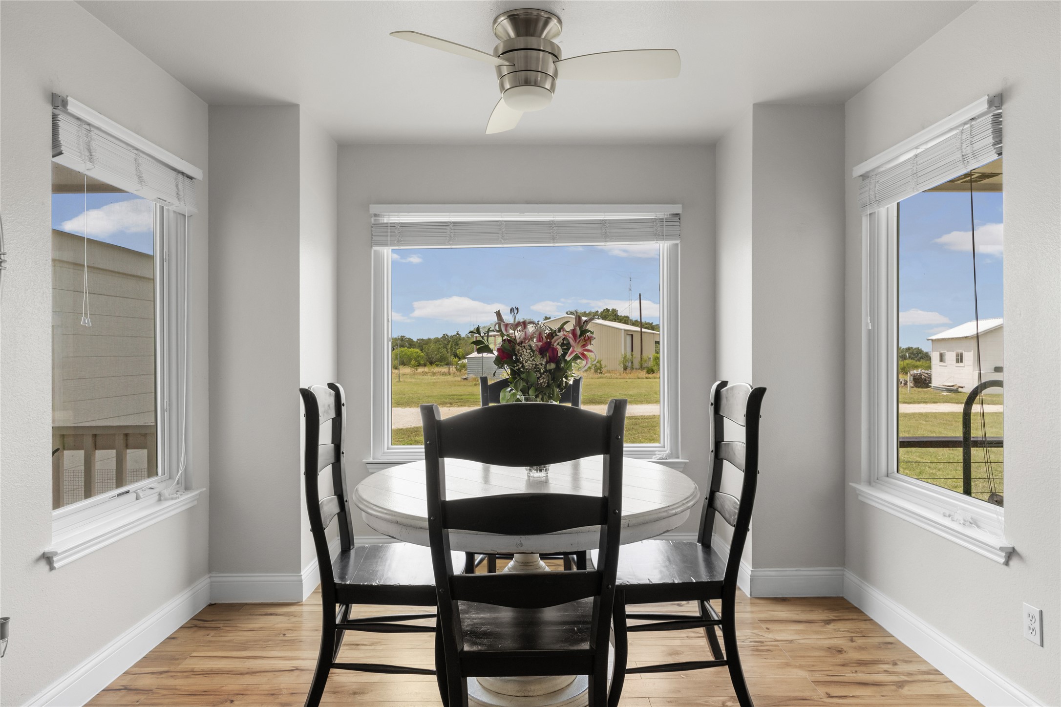 1283 Rattlesnake Trail Burnet, TX 78611 - Photo 17 of 39 a view of a dining room with furniture window and wooden floor