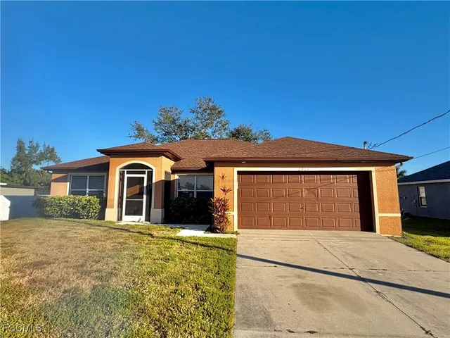 a front view of a house with a yard and garage