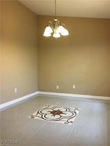 a view of a livingroom with a table and chairs