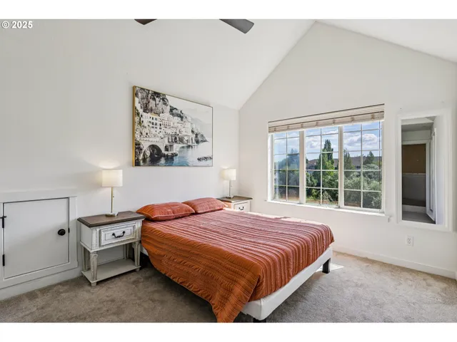 a bedroom with a bed and a large window